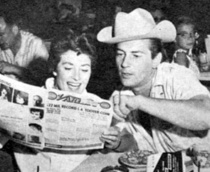 Jack Kelly and wife May Wynn check out the latest VARIETY tradepaper news. 