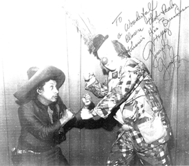 Pedro Gonzalez Gonzalez strikes a fighting pose with Happy the Clown (aka Dave Twomey). 