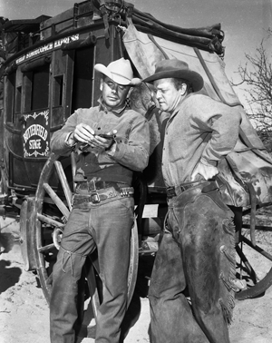 Glenn Ford and Van Heflin in a discussion about Ford's gun while filming “3:10 to Yuma” at Old Tucson, AZ. 