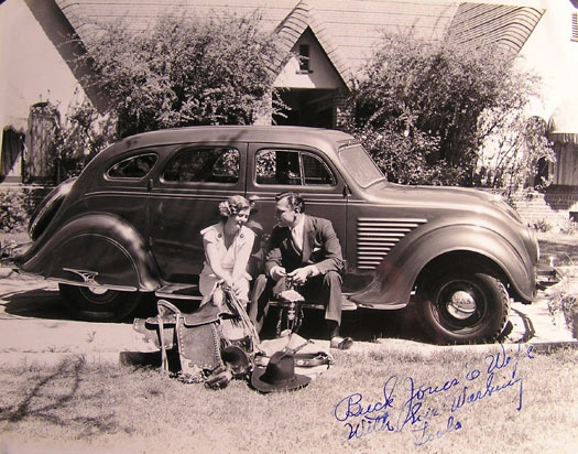 The caption reads “Buck Jones and wife [Dell] with his working tools [saddle, rope, hat, bridle, etc.].” Taken in front of Buck’s home. (Can anyone identify the make and year of Buck’s car?) (Thanx to Bobby Copeland.)