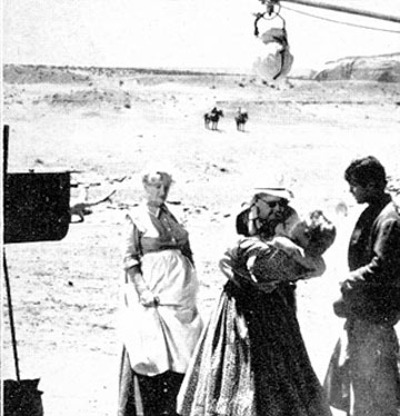 Olive Carey and Jeffrey Hunter observe as John Ford demonstrates the embrace he wants for a “Searchers” scene.