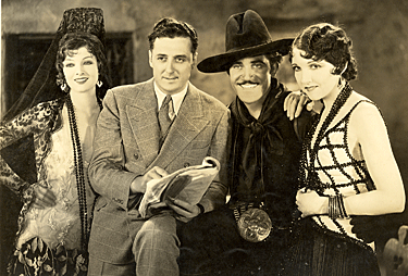 The cast of “Rogue of the Rio Grande” (‘30 Sono-Art). (L-R) Myrna Loy, director Spencer Gordon Bennet, Jose Bohr, Carmelita Geraghty. 