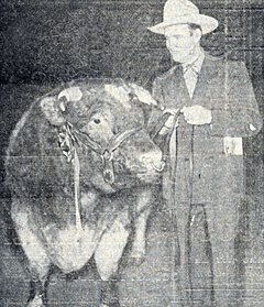 Gene Autry stands beside Arngibbon Reserve, Grand Champion Shorthorn bull at the April 1942 Southwest Rodeo and Fat Stock Show at Fort Worth, Texas. 