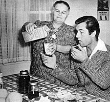Breakfast in July 1942 before heading off to the studio, George Montgomery ’s mother pours him a glass of milk. 