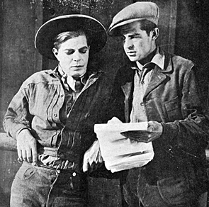 Director Mack V. Wright (right) and Hoot Gibson go over a script for one of their 1918 two-reel Westerns. When this photo was taken, Wright, who had a long career as a director, was one of the youngest directors in the business.