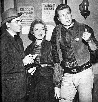 Columnist Army Archerd turns actor for an episode of “Cimarron City: The Bitter Lesson” in 1959 with stars Audrey Totter and John Smith. 