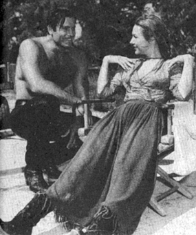 Between scenes while making "Fort Dobbs", Clint Walker chats with Virginia Mayo. 