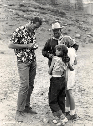 John Wayne signs a couple of autographs on location for "Fort Apache".
(Thanx to Ken Kitchen.) 