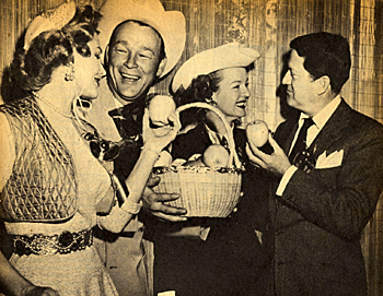 Roy Rogers received the 1954 Hollywood Women's Press Club award, The Golden Apple, for most cooperative male star. Virginia Mayo (left) just missed out in the Women's division. Roy's wife Dale Evans and actor/husband of Mayo, Michael O'Shea congratulate them.