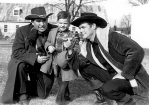 Charles Starrett (right) and screen badman George Lloyd show a young fan how to aim his toy pistol while on a promotional tour in the late '40s. (Thanx to James [Nikki] Ellerbe.) 