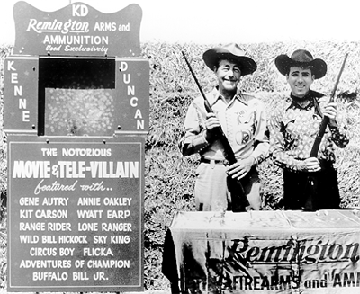 Western badman Kenne Duncan and sidekick Dale Berry during a personal appearance at the 1957 Indiana State Fair in Indianapolis. Kenne was obviously doing a little promotional tie-in for Remington. 