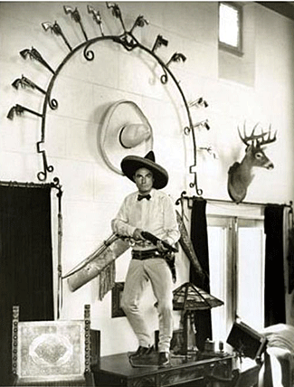 Tom Mix had to stand on a table to get this photo of himself in his den just right. 