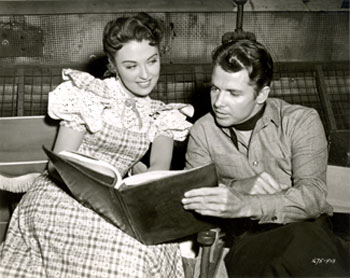 Beverly Tyler and Audie Murphy study their script for “The Cimarron Kid” (‘51 Universal).