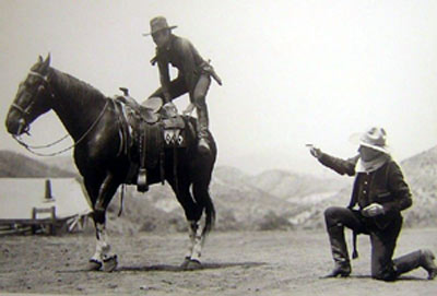 William S. Hart coaches Johnny Mack Brown on how to do a crouper mount during the filming of “Billy the Kid” (‘30 MGM).