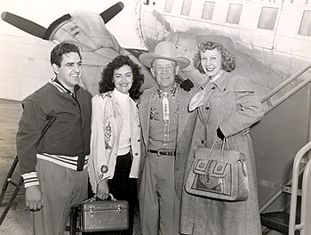 A group of Western entertainers had just returned from a series of shows for some 32,000 hospitalized Korean Veterans at Mare Island, Oakland Navy Hospital, Letterman Army General Hospital and Oak Knoll Hospital. Pictured here: unknown, unknown, Tom London, Carolina Cotton. Also on the tour were Chill Wills, Andy Clyde, Eddie Dean and others