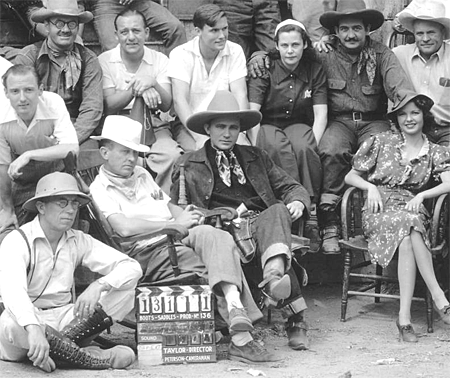 Cast and crew of “Tex Rides With the Boy Scouts” (‘38 Grand National). Identified are Ed Cassidy (top row left), Charlie King (top row, 2nd from right), cameraman Gus Peterson (bottom left), director Ray Taylor (in chair), Tex Ritter, Marjorie Reynolds. (Thanx to Ed Tabor, Chuck Anderson.)