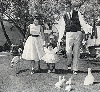 Rory "The Texan" Calhoun and wife Lita Baron take daughter Cindy for a walk in the park. 