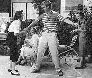 Will "Sugarfoot" Hutchins tries a spot of jitterbugging with his niece
Lesley while his mom (right), sister-in-law Polly and younder niece Gay
look on in amusement. 