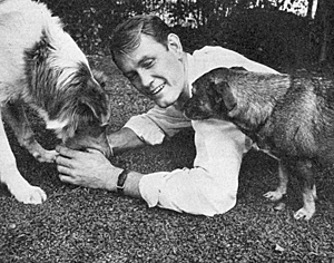 "Hotel de Paree" TV star Earl Holliman relaxes with two of his canine pets.