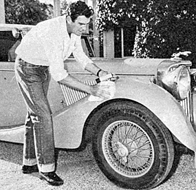 Rod Cameron polishes his classic car in his driveway.