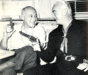 William "Hopalong Cassidy" Boyd compares his six-shooter with that of director Cecil B. DeMille in 1952. 