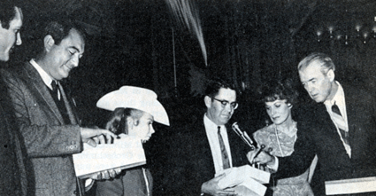 In Fort Worth, TX, in March 1966 as part of the publicity ballyhoo for Universal's "The Rare Breed" premeire are (L-R) Don Galloway, director Andrew McLaglen, Juliet Mills, unknown, Maureen O'Hara and James Stewart.