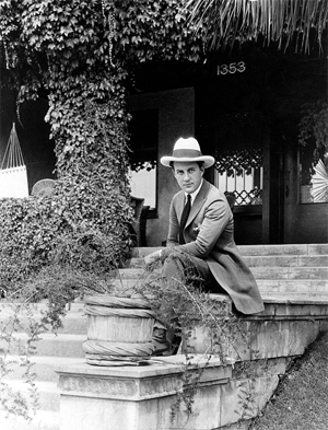 '30s B-Western star Jack Perrin relaxes in front of his home.