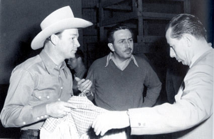 Roy Rogers meets with Walt Disney (center) and a Disney costumer preparing for Roy’s role in the “Pecos Bill” segment of “Melody Time” (‘48).