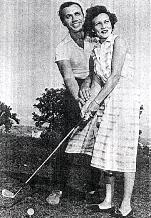 Golfer Michael Ansara, Cochise on “Broken Arrow”, gives a few pointers to Betty White, then star of “A Date with the Angels”.