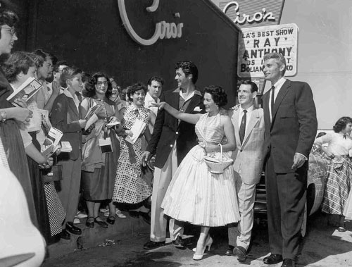 Rory Calhoun (left) and Jeff Chandler (right) attend the opening for Ray Anthony and his Orchestra at Ciro’s nightclub at 8433 Sunset Blvd. in West Hollywood in the mid ‘50s. That’s bandleader Ray Anthony beside, we believe, Anthony’s band singer April Ames.