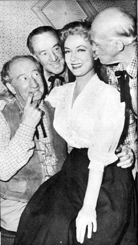 In between scenes for TV’s “Cimarron City”, Audrey Totter is surrounded by former silent comedians, Hank Mann, Snub Pollard and Matthew McCue, all of whom now work as extras on the series.