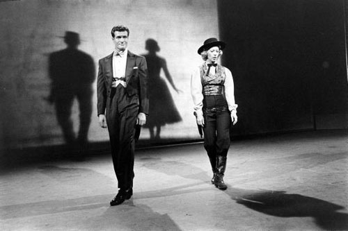 Hugh O’Brian and Dinah Shore doing a shadow dance on the “Dinah Shore Show”. Note the Wyatt Earp shadow behind Hugh and Dinah with a dress. 