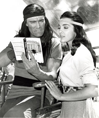 Chuck Connors and Kamala Devi take a break from filming "Geronimo" ('62 U.A.) to read a bit of James A. Michner's HAWAII. Connors and Devi fell in love while making the movie and were married from April 10, 1963 to 1972. (Thanx to Neil Summers.)