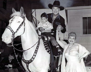 Hopalong Cassidy and a youngster fan poses with famous striptease artist Sally Rand at the Cotton Bowl in Dallas, TX, on 10/10/52. (Thanx to Bobby Copeland and Billy Holcomb.)