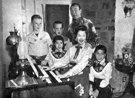 Roy Rogers and Dale Evans and four of their children sing Christmas Carols at their home in Chatsworth, CA. (L-R) Roy “Dusty” Rogers Jr., Sandy, Debbie and Dodie.