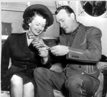 In 1947 Roy measures the finger of his bride-to-be, Dale Evans, for a ring.