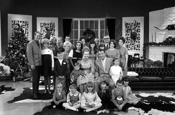 Roy and Dale with six children, four spouses at the time and 13 grandchildren at a taping of the “Jonathan Winters Christmas Show” in December 1968. (L-R) Dusty, Linda Yoder Rogers (no children as they married 11/67), Linda Rogers Johnson holding her son Robin Roy with husband Gary Johnson, Mimi Easton Swift in front of Johnson (she was then widowed and had not married Swift yet), Dodie is next to Mimi with white headband, Cheryl Rogers Rose Barnett, her first husband Bill Rose. Next to Bill is Tom and Barbara Fox on far right. Tom and Barbara’s three girls are in front of them--Candy with the long hair, Julie and Mindy with short hair. Nine grandchildren are in front.