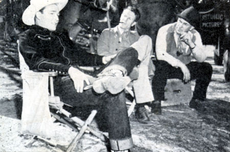 At Republic, Roy takes a break with director Frank McDonald (with pipe in mouth) while filming “Rainbow Over Texas” (‘46).