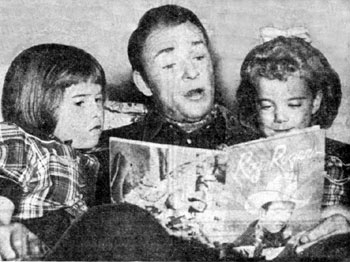 Roy entertains daughters Cheryl (left) and Linda Lou (right) by reading some of his comic book adventures from ROY ROGERS Dell #1 (1948).