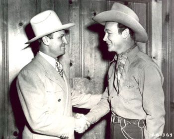 There’s certainly no “feud” here as Republic’s two top cowboys shake hands. Gene Autry and Roy Rogers.