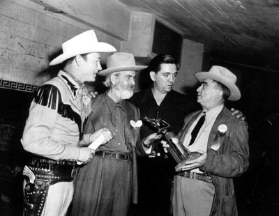L.A. Sheriff Gene Biscailuz shows Roy, Gabby Hayes and Stuart Hamblin the award to be used at the “Western Hall of Fame Hoss Opera” held at L.A.’s Olympic Auditorium 11/28/48.