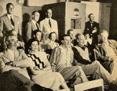 During filming, daily rushes for Paramount's “Branded” were shown every night at the hotel. Seated in the front row are George J. Lewis (center) and Charles Bickford (R). Seated in the second row are Peter Hansen, Mona Freeman, Alan Ladd and Ladd’s wife Sue Carroll. Standing at the far right is producer Mel Epstein.