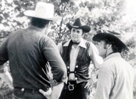 Sunset Carson in a scene from “Marshal of Windy Hollow” with Bruce Embry (L) and Jerry Whittington (R).