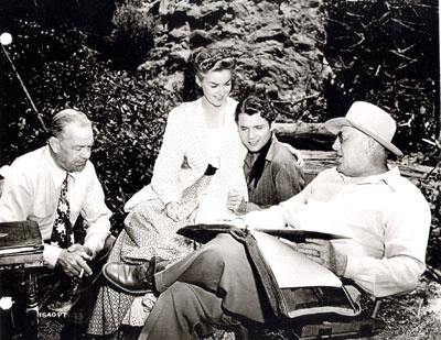 Dialogue director Gene Lewis, Marguerite Chapman, Audie Murphy and director Ray Enright discuss a scene for “Kansas Raiders” (‘50 Universal-International).