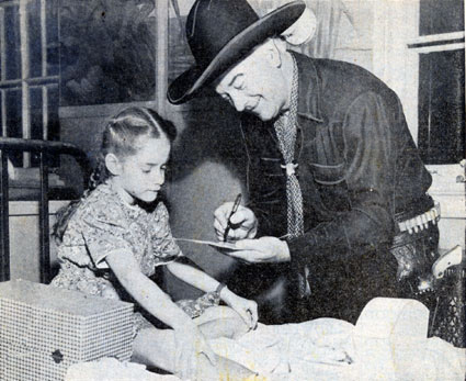 Hopalong Cassidy signs an autograph for Georgia, a young patient at the Shriner’s Hospital for Crippled Children in Chicago in 1950.