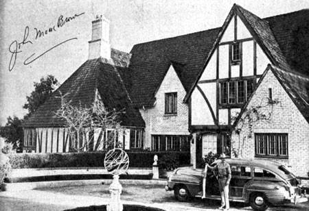 Cars of the Stars: Johnny Mack Brown in front of his 16 room English Colonial house in Beverly Hills in early 1946.