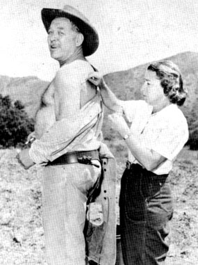 Nurse Maxine Schulze administers first aid to Ward Bond for a cut he received while on location for “Wagon Train” in 1960.
