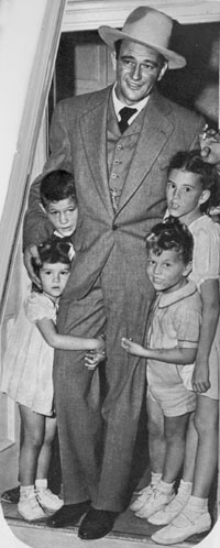 John Wayne in late 1944 with his children, Michael and Pat and the girls Toni and Melinda. 