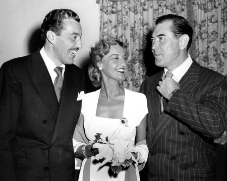Johnny Mack Brown straightens his tie while talking to former Cisco Kid Cesar Romero and singer Jeanette MacDonald at a Hollywood function in 1948. (Thanx to Bobby Copeland.)