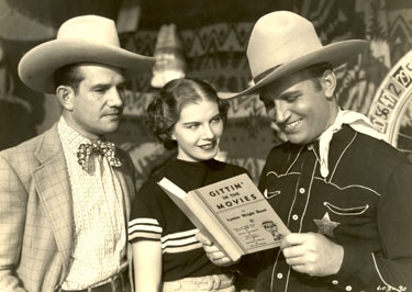 Already a star by 1936 when Gene Autry was making “The Old Corral”, he gets a chuckle out of the book GITTIN’ IN THE MOVIES while his leading lady Hope Manning and Cornelius Keefe look on.